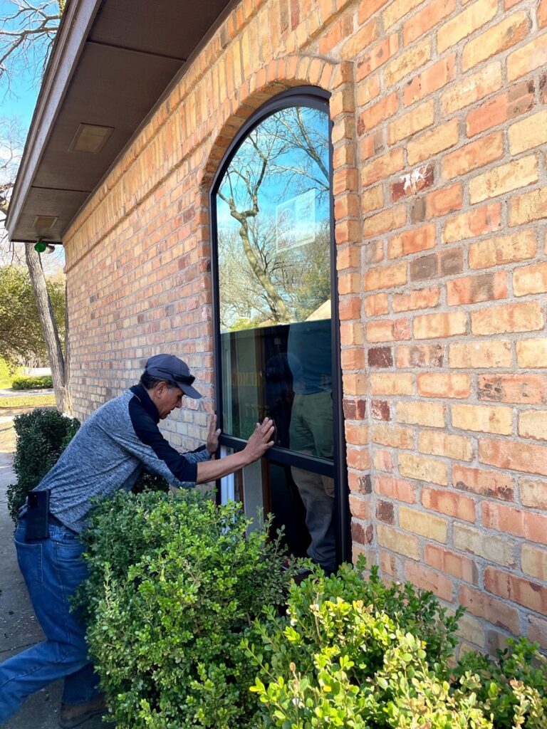 A-man-installing-energy-efficient-picture-replacement-windows-in-scottsdale